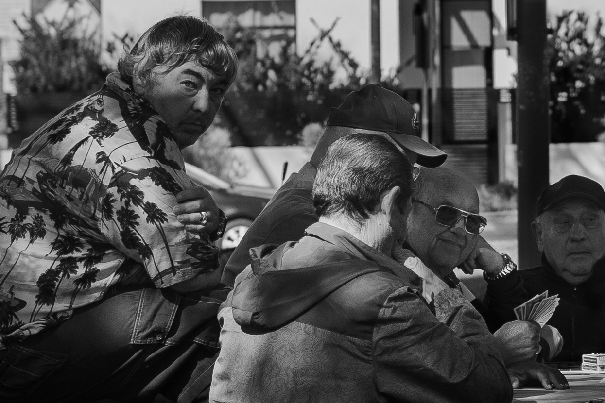 Men playing cards outdoors